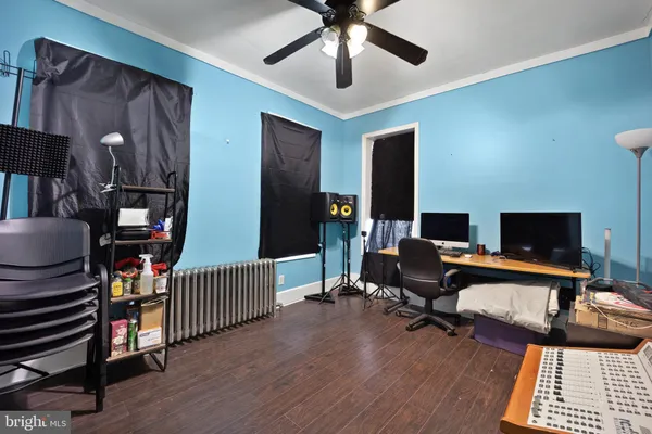 a view of a livingroom with workspace and a window