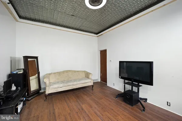 a bedroom with furniture and a flat screen tv
