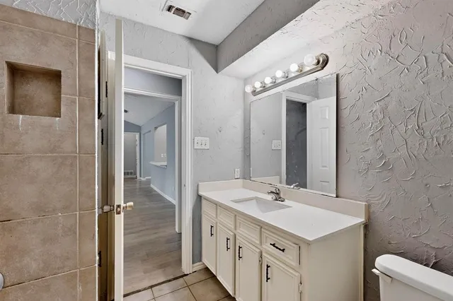a bathroom with a double vanity sink mirror and shower