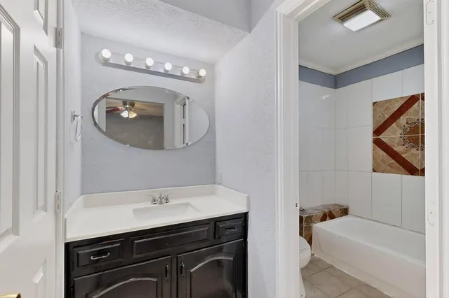 a bathroom with a sink a tub and a mirror