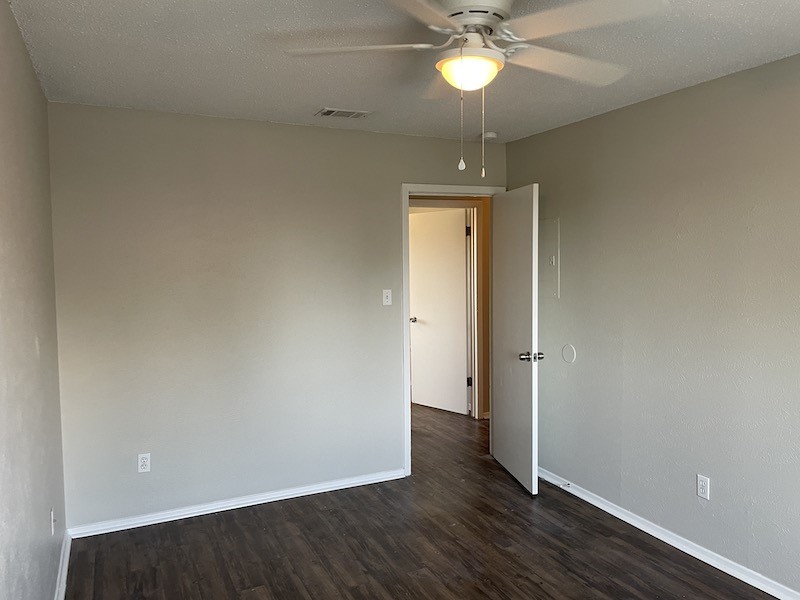 8401 Colony Loop Drive, Unit D Austin, TX 78724 - Photo 12 of 18 an empty room and wooden floor fan