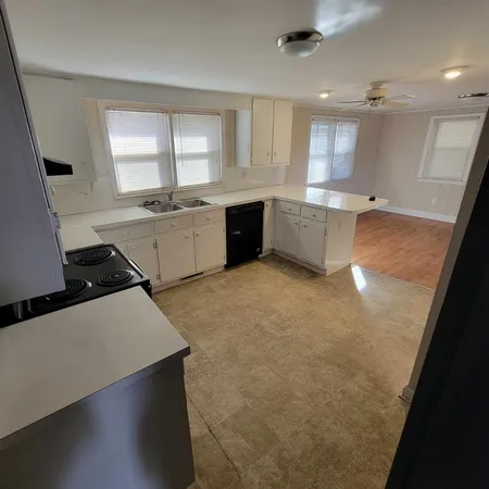 a large kitchen with a large window
