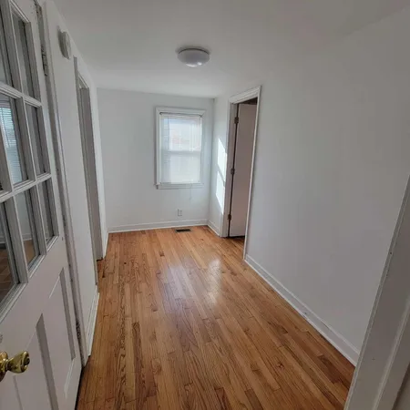 a view of a room with wooden floor and staircase