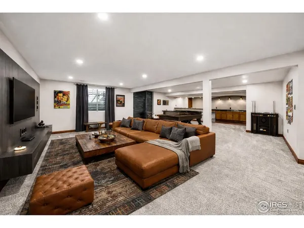 a living room with furniture pool table and a lamp