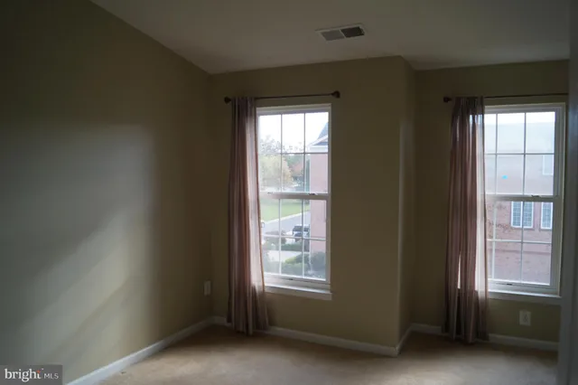 a view of an empty room and a window