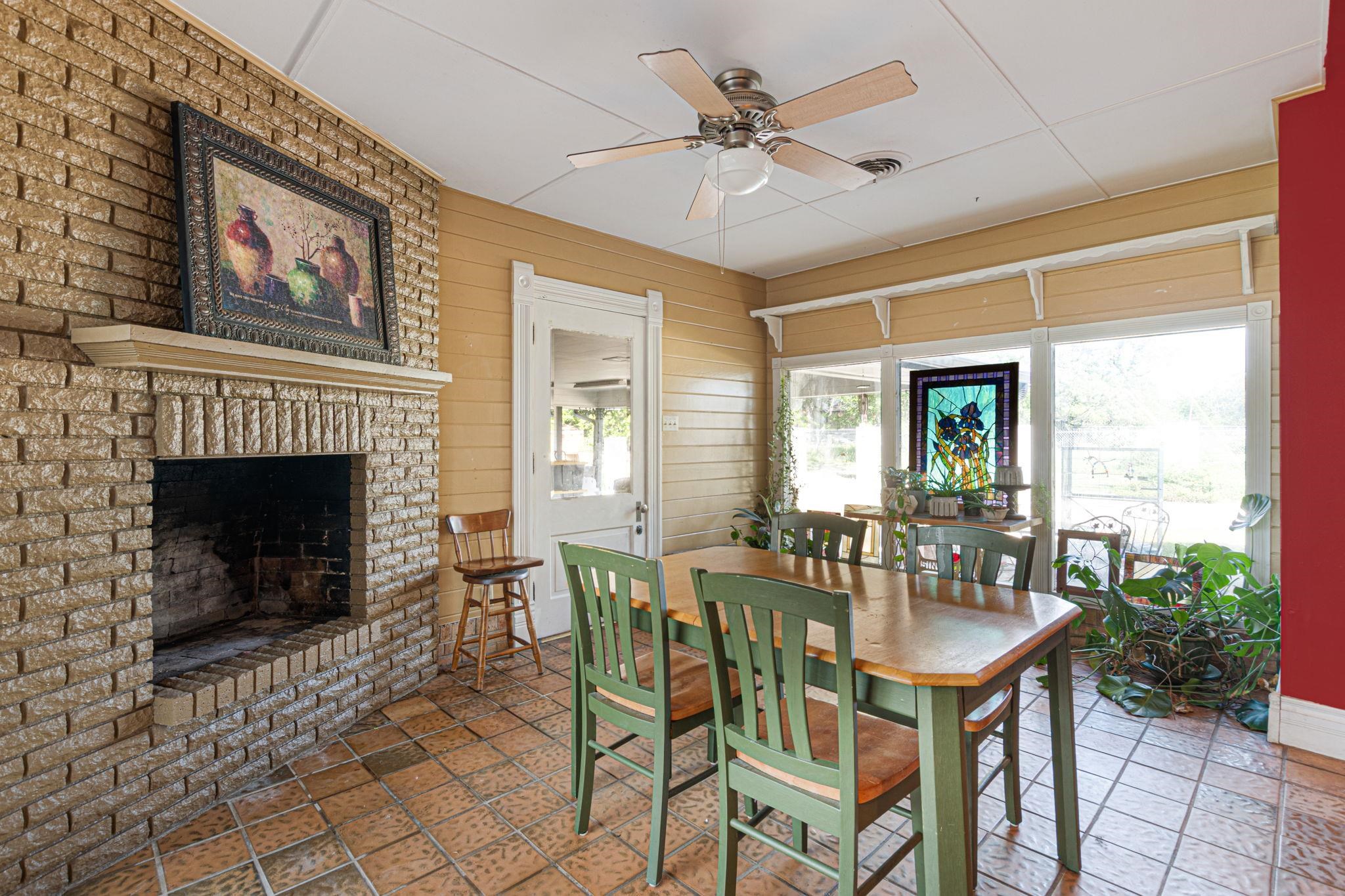 106 South Howe Street Lampasas, TX 76550 - Photo 12 of 29 a dining room with furniture a fireplace and large windows
