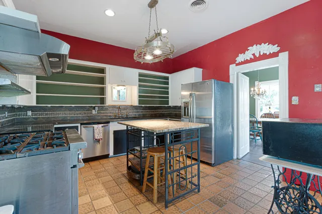 a kitchen with stainless steel appliances granite countertop a stove and a sink