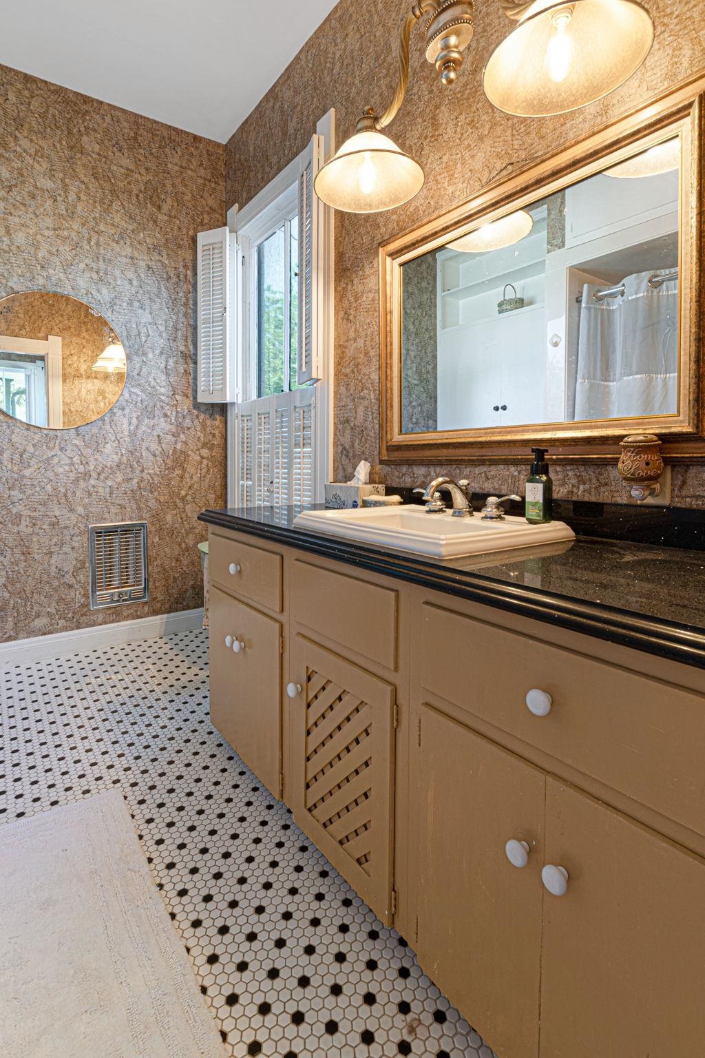 106 South Howe Street Lampasas, TX 76550 - Photo 23 of 29 a bathroom with a sink a vanity and a mirror