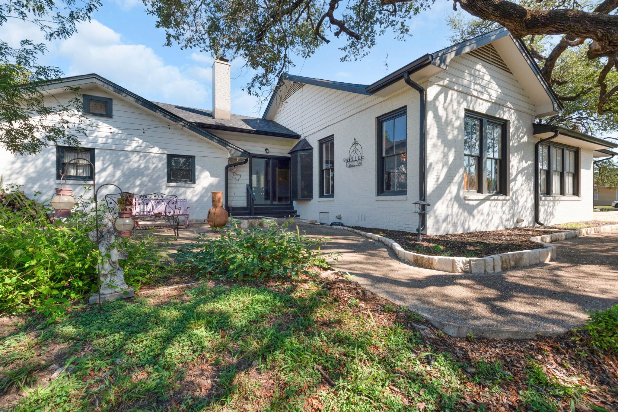 106 South Howe Street Lampasas, TX 76550 - Photo 3 of 29 a front view of a house with garden