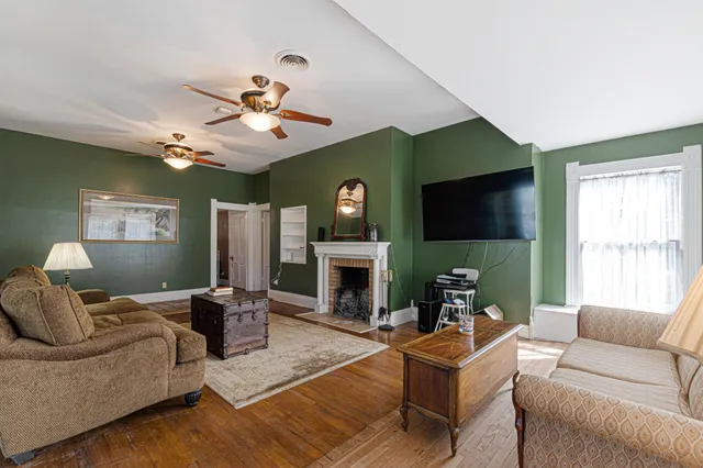 a living room with furniture a fireplace and a flat screen tv