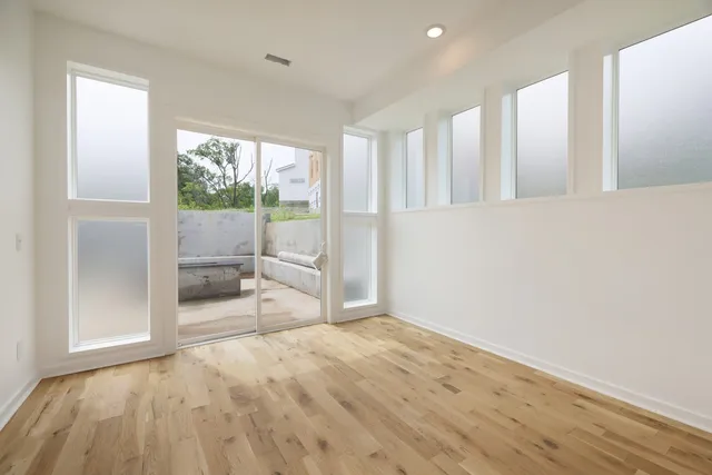 a view of a room with wooden floor and outdoor space