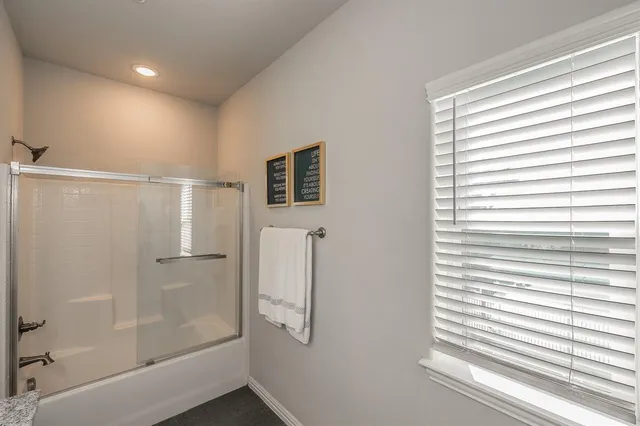 a bathroom with a shower and a tub