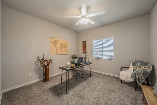 a workspace with wooden floor and a window