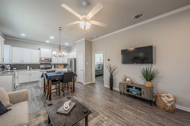 a living room with furniture and a flat screen tv
