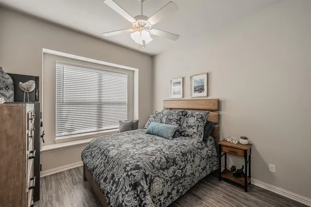 a bedroom with a bed dresser and a window