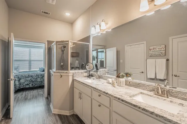 a bathroom with a granite countertop sink mirror and double