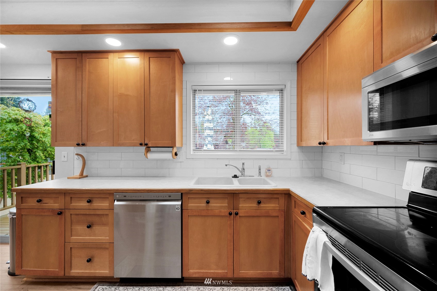 21823 2nd Avenue West Bothell, WA 98021 - Photo 3 of 30 a kitchen with stainless steel appliances granite countertop a sink a stove and a microwave