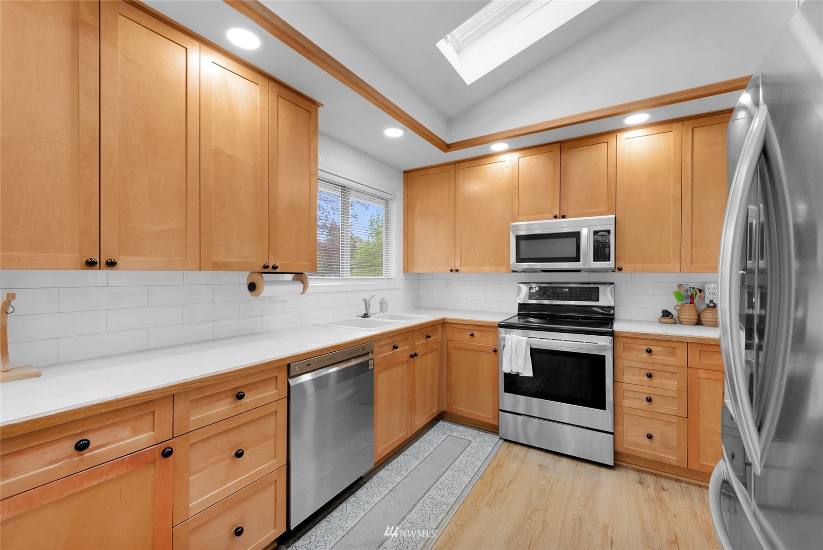 21823 2nd Avenue West Bothell, WA 98021 - Photo 4 of 30 a kitchen with stainless steel appliances a stove sink and cabinets