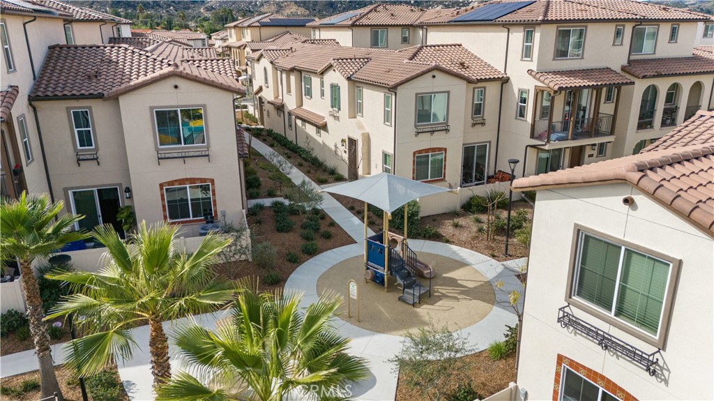 31305 Via Nubes Temecula, CA 92592 - Photo 2 of 27 a view of a white house with large windows next to a road