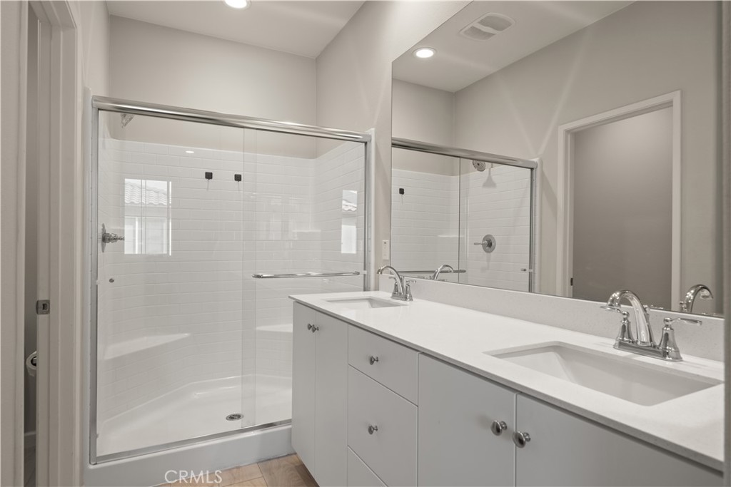 31305 Via Nubes Temecula, CA 92592 - Photo 23 of 27 a bathroom with a shower sink and mirror