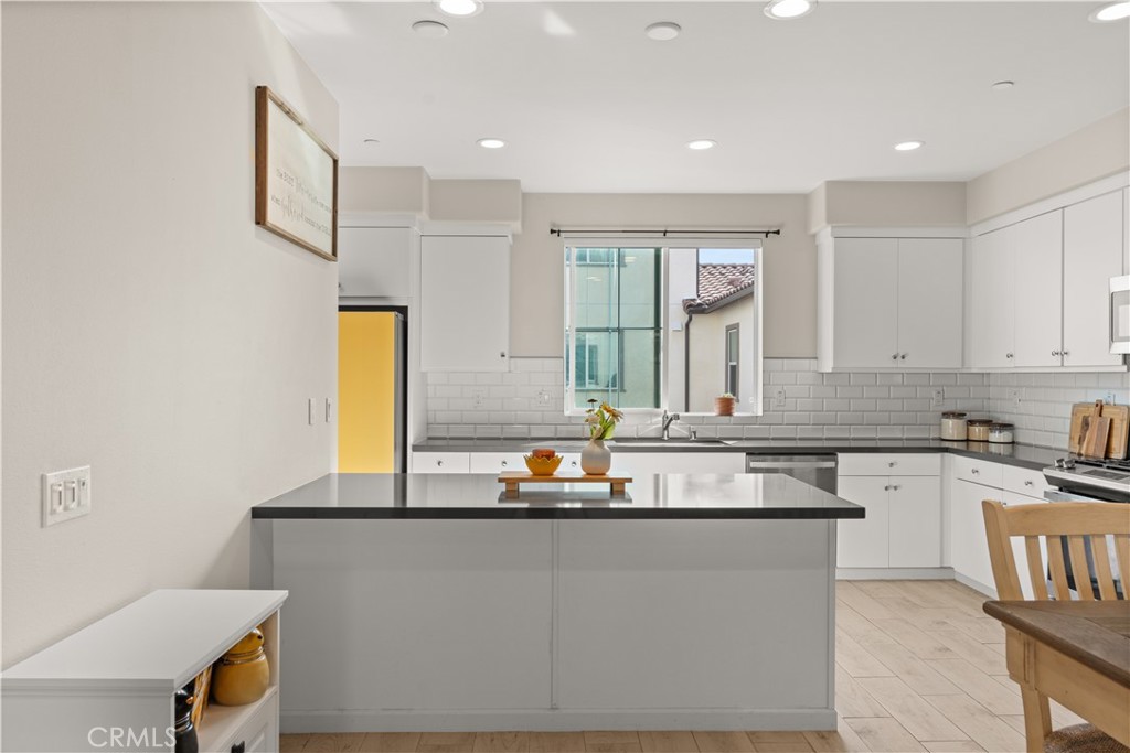 31305 Via Nubes Temecula, CA 92592 - Photo 6 of 27 a kitchen with kitchen island granite countertop a sink and a stove