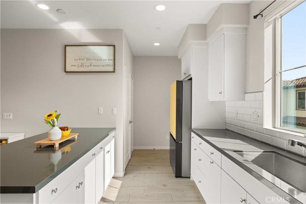 31305 Via Nubes Temecula, CA 92592 - Photo 9 of 27 a kitchen with a sink and wooden cabinets