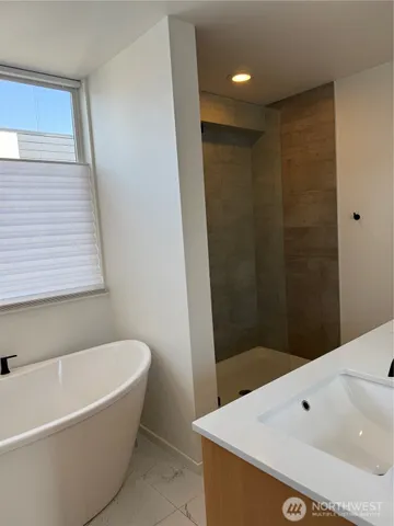 a bathroom with a bathtub and shower