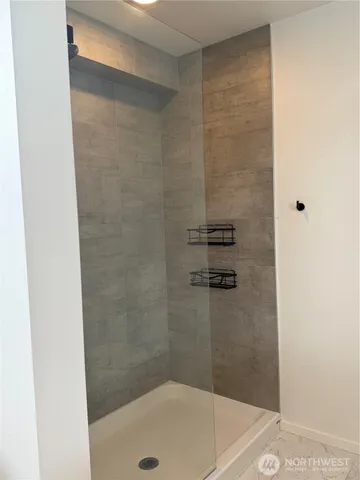 a bathroom with a shower and a bathtub