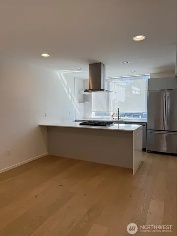 a kitchen with stainless steel appliances a sink and a refrigerator