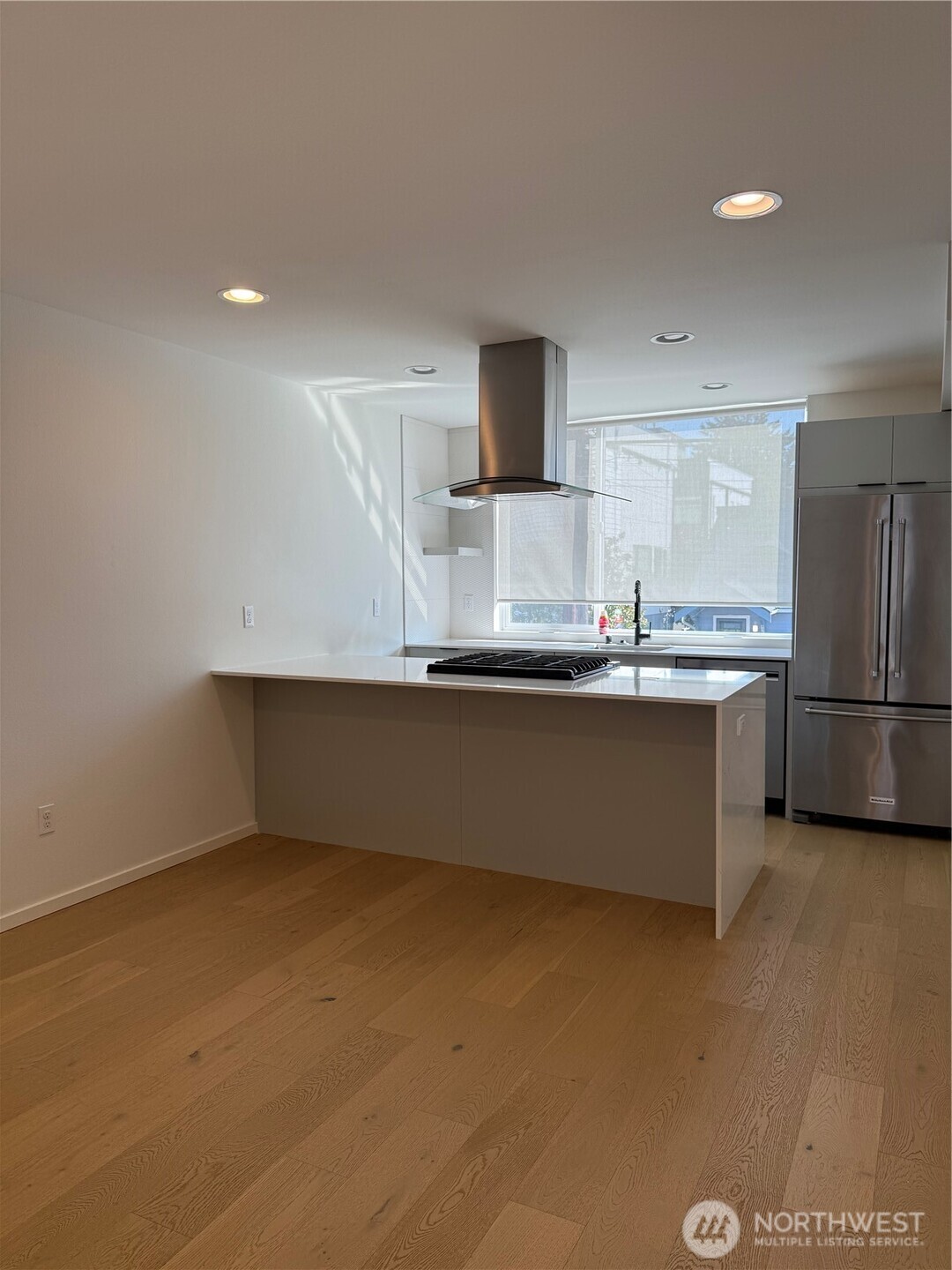 817 24th Avenue South, Unit B Seattle, WA 98144 - Photo 5 of 33 a kitchen with stainless steel appliances a sink and a refrigerator