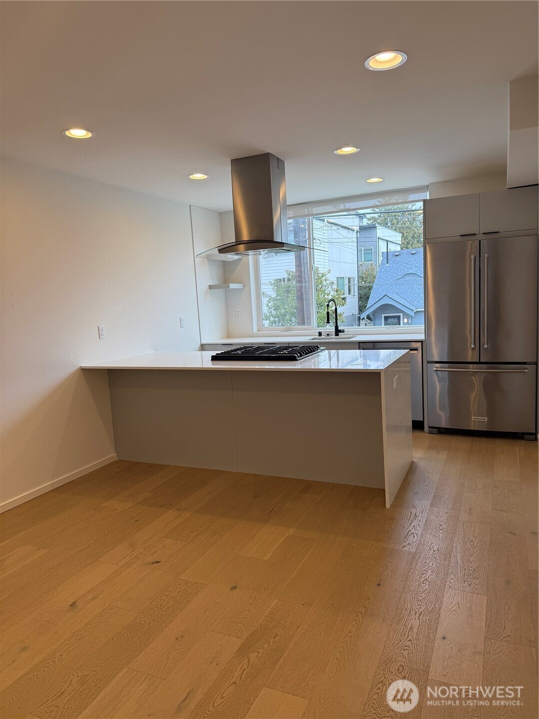 817 24th Avenue South, Unit B Seattle, WA 98144 - Photo 6 of 33 a kitchen with stainless steel appliances granite countertop a refrigerator and a stove top oven