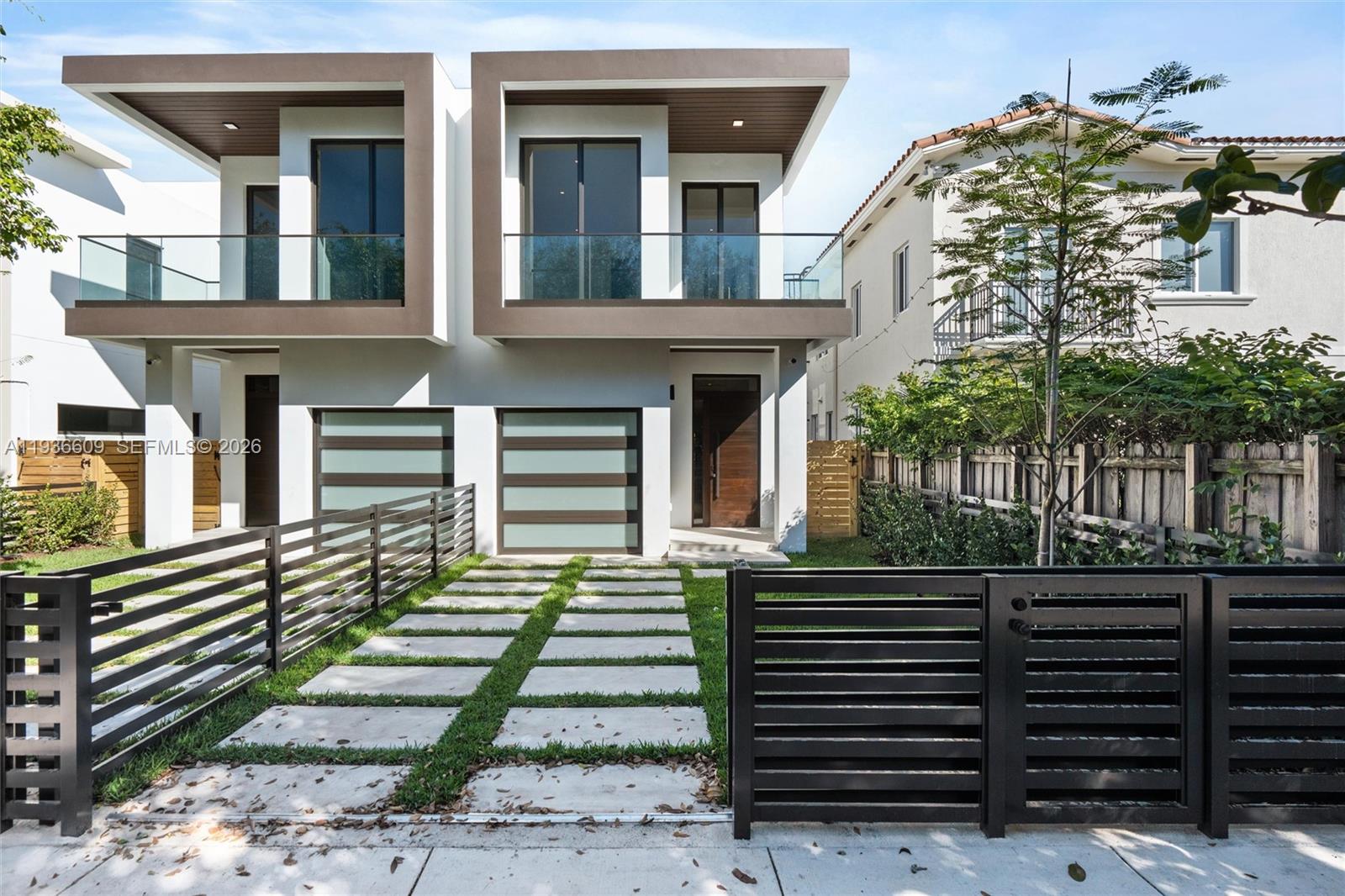 a front view of a house with a garden