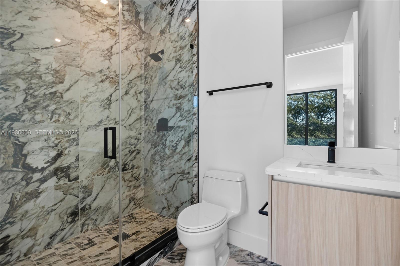 1247 Southwest 13th Avenue Miami, FL 33135 - Photo 18 of 22 a bathroom with a granite countertop toilet and a sink