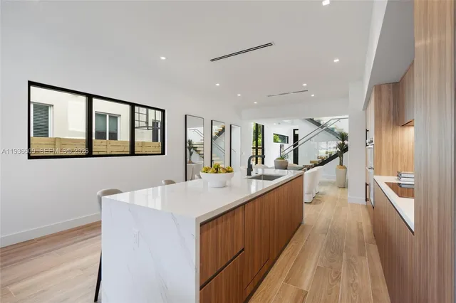 a view of a kitchen with a sink and wooden floor