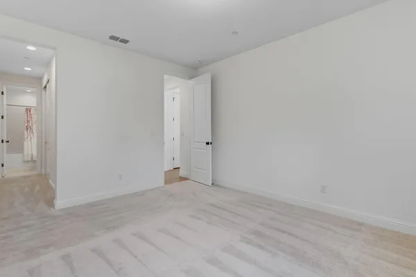 a view of a hallway with wooden floor and entryway
