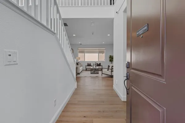 a view of a hallway with the wooden floor and staircase