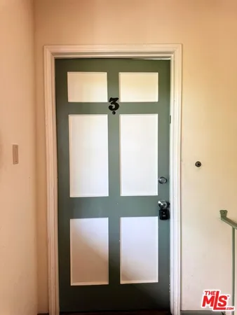 a view of a house with a yard and potted plants