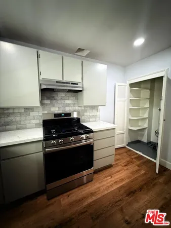a kitchen with a stove and a refrigerator
