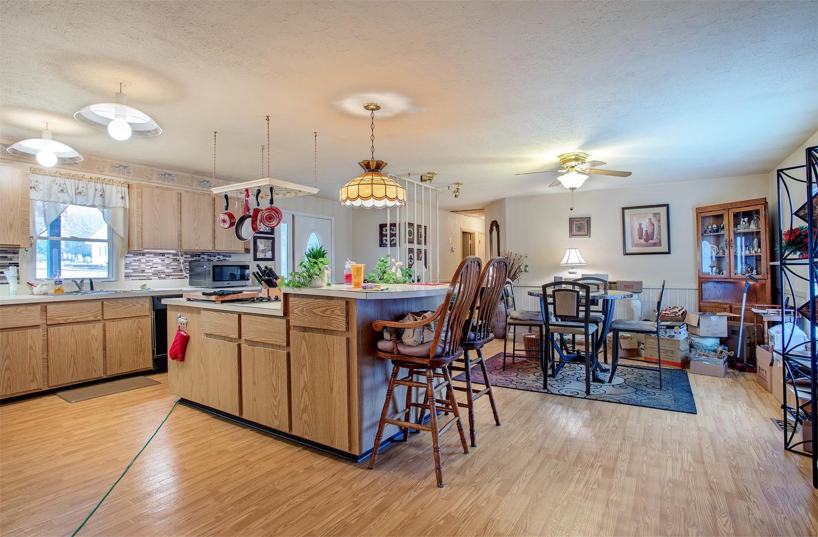 1803 Friendship Road Cross Plains, TN 37049 - Photo 5 of 20 a kitchen with stainless steel appliances granite countertop a table chairs stove a sink dishwasher and cabinets