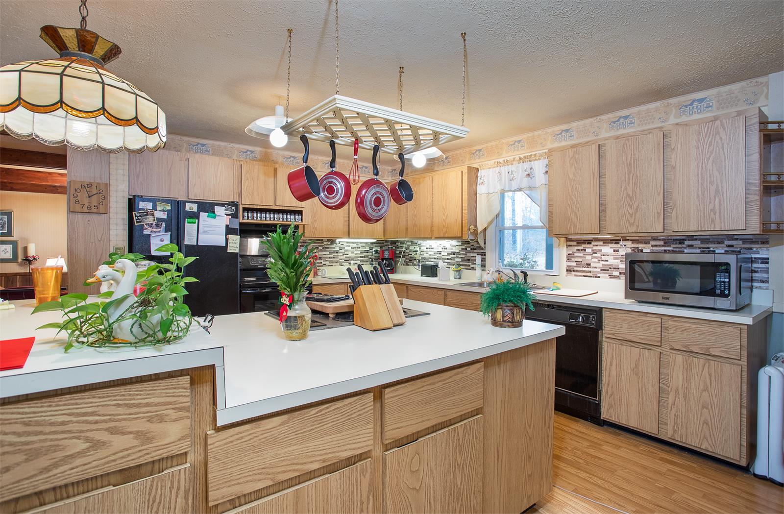 1803 Friendship Road Cross Plains, TN 37049 - Photo 6 of 20 a kitchen with stainless steel appliances granite countertop a sink a stove and a wooden floor