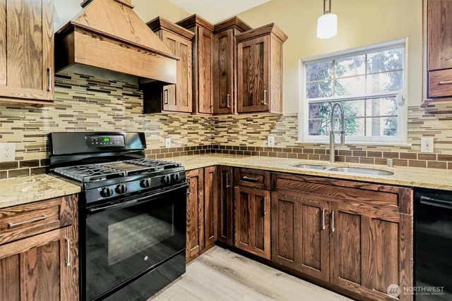 a kitchen with stainless steel appliances granite countertop a stove and a sink