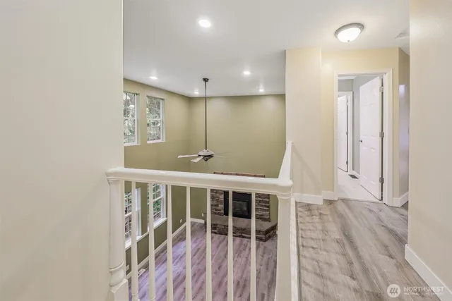 a view of a big room with wooden floor and windows