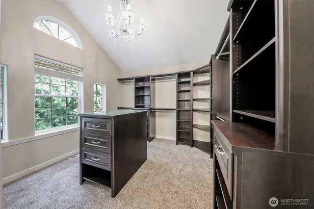 a view of walk in closet with clothes and shoes