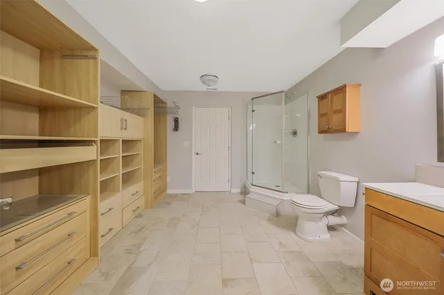 a bathroom with a toilet a sink and shower