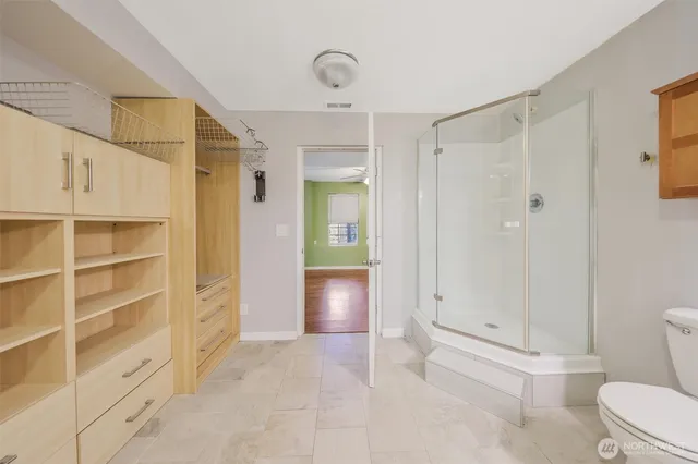 a bathroom with a shower and a toilet