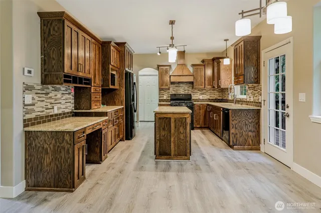 a kitchen with stainless steel appliances granite countertop a stove a sink dishwasher a refrigerator and a oven