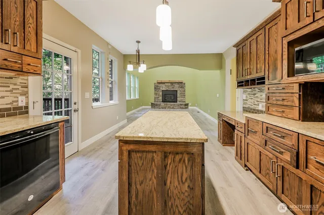 a kitchen with stainless steel appliances a stove sink microwave and cabinets