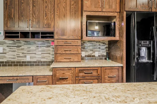 a kitchen with stainless steel appliances kitchen island granite countertop a stove a sink and a microwave