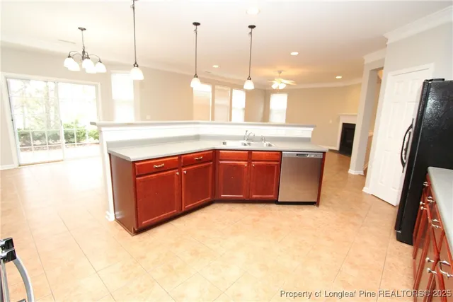 a kitchen with stainless steel appliances granite countertop a sink a stove and a wooden floors