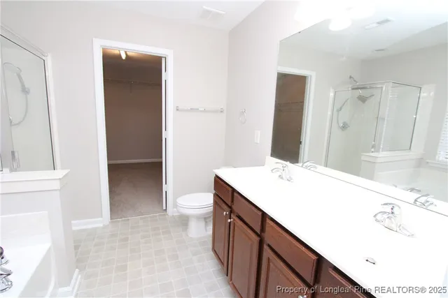 a bathroom with a sink a toilet and a shower